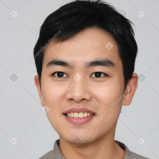 Joyful asian young-adult male with short  black hair and brown eyes