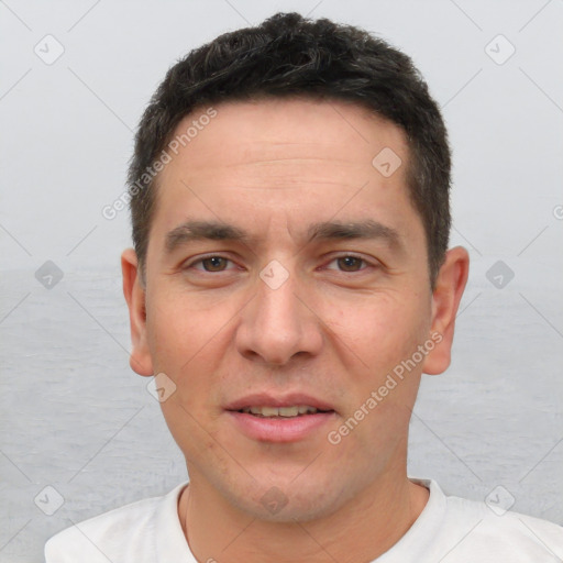 Joyful white adult male with short  brown hair and brown eyes