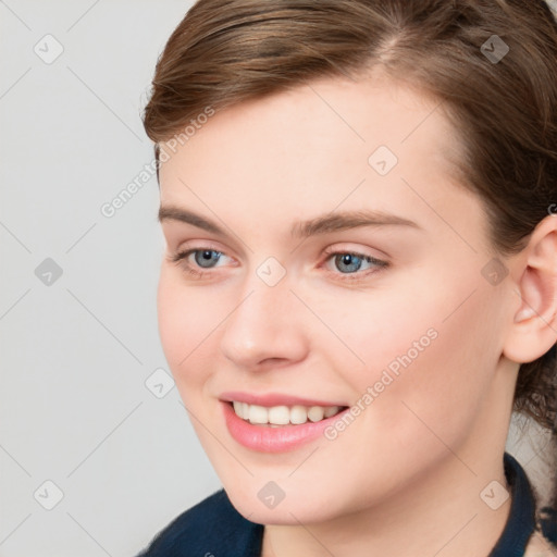 Joyful white young-adult female with medium  brown hair and blue eyes