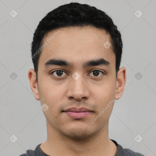 Neutral latino young-adult male with short  black hair and brown eyes