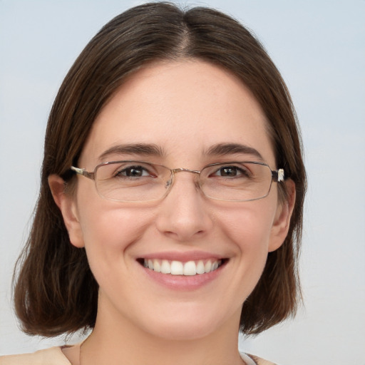 Joyful white young-adult female with medium  brown hair and grey eyes