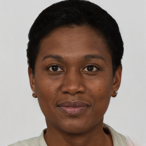 Joyful black young-adult female with short  black hair and brown eyes