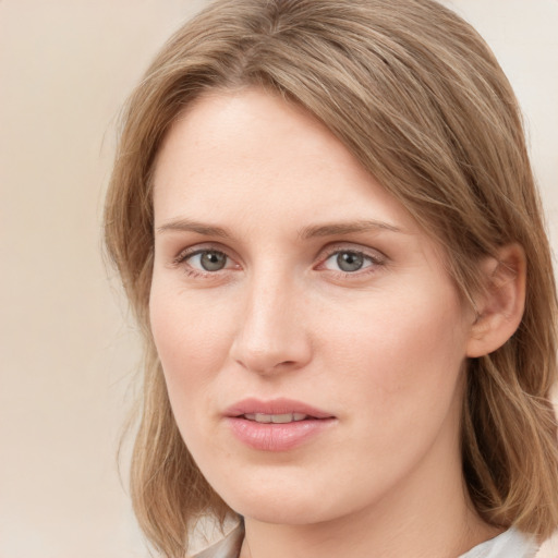 Joyful white young-adult female with medium  brown hair and blue eyes