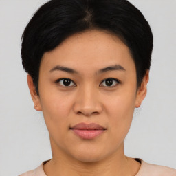 Joyful asian young-adult female with short  black hair and brown eyes