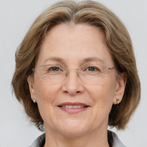 Joyful white middle-aged female with medium  brown hair and grey eyes