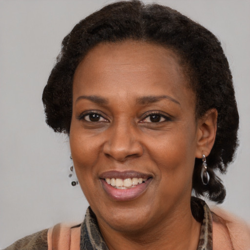 Joyful black adult female with short  brown hair and brown eyes