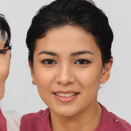Joyful asian young-adult female with medium  black hair and brown eyes
