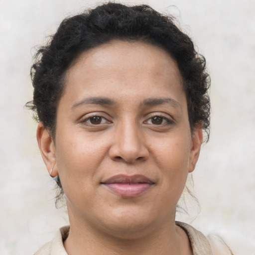 Joyful latino young-adult female with short  brown hair and brown eyes