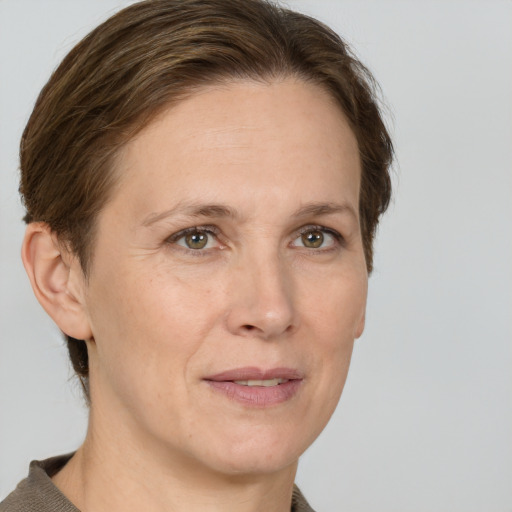 Joyful white adult female with short  brown hair and grey eyes