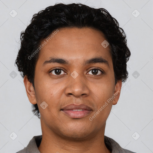 Joyful latino young-adult male with short  brown hair and brown eyes