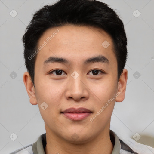 Joyful asian young-adult male with short  black hair and brown eyes