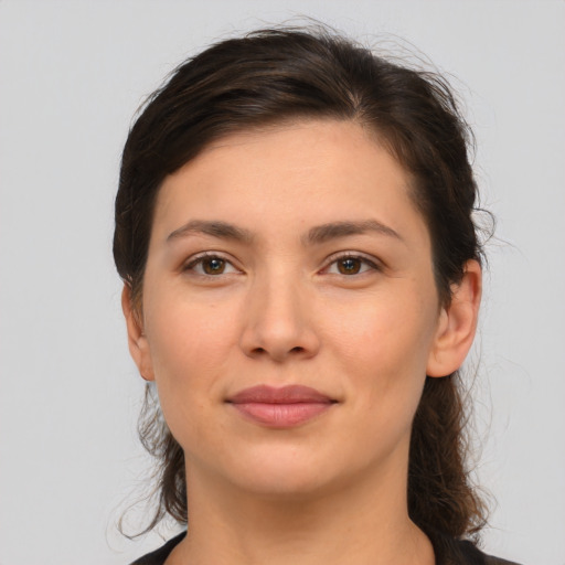 Joyful white young-adult female with medium  brown hair and brown eyes