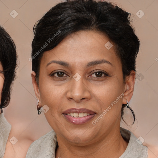 Joyful latino adult female with medium  brown hair and brown eyes