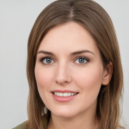 Joyful white young-adult female with long  brown hair and green eyes