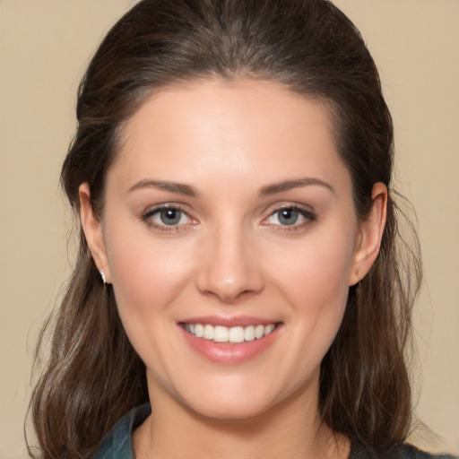 Joyful white young-adult female with medium  brown hair and brown eyes