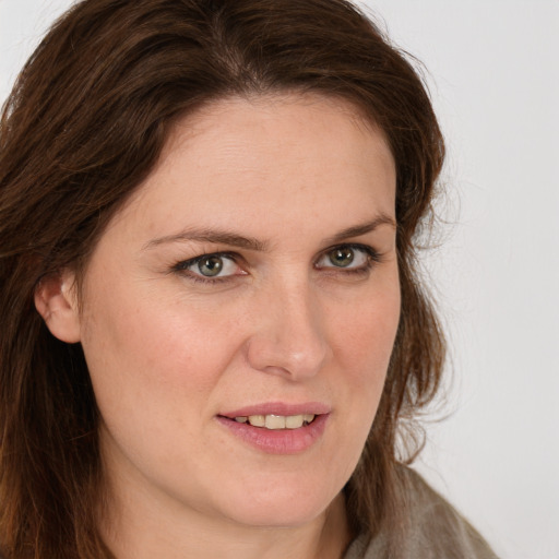 Joyful white young-adult female with long  brown hair and green eyes