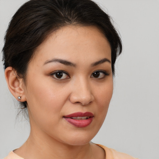 Joyful white young-adult female with medium  brown hair and brown eyes