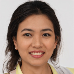 Joyful latino young-adult female with medium  brown hair and brown eyes