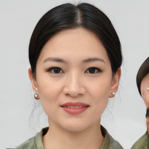 Joyful asian young-adult female with medium  brown hair and brown eyes