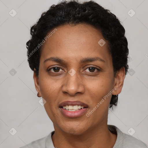 Joyful black adult female with short  black hair and brown eyes