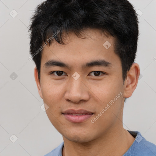 Joyful asian young-adult male with short  black hair and brown eyes