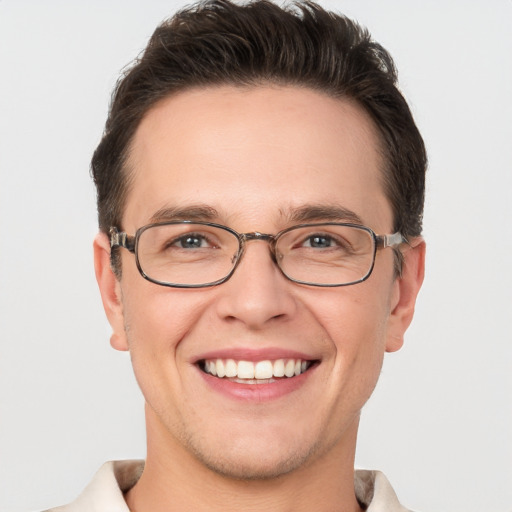 Joyful white adult male with short  brown hair and brown eyes