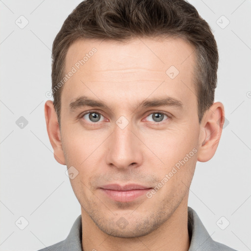 Joyful white young-adult male with short  brown hair and grey eyes