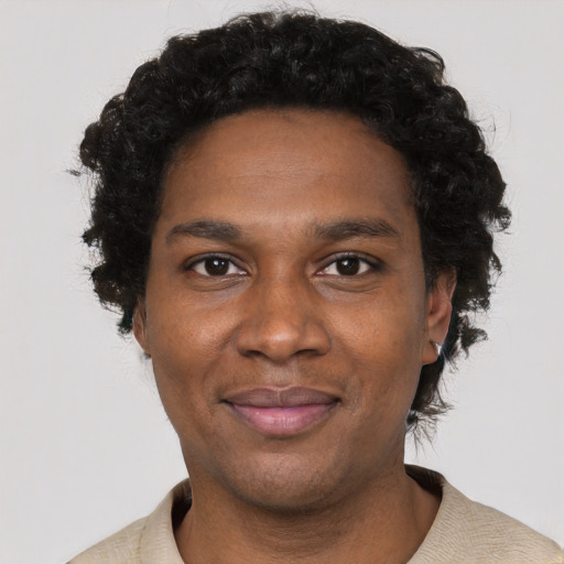 Joyful black young-adult male with short  black hair and brown eyes