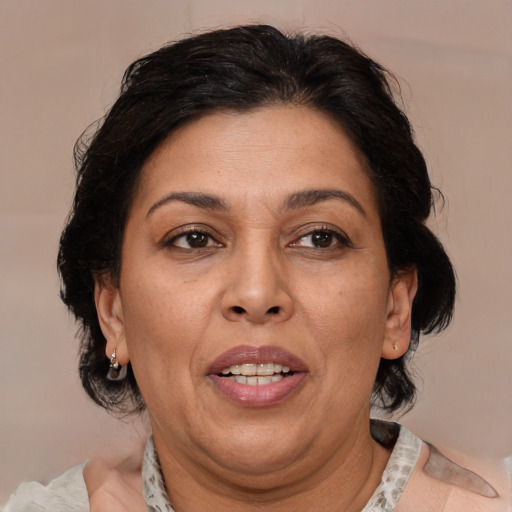 Joyful black adult female with medium  brown hair and brown eyes