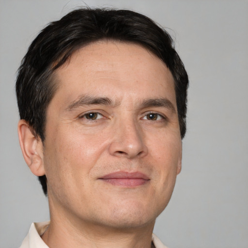 Joyful white adult male with short  brown hair and brown eyes