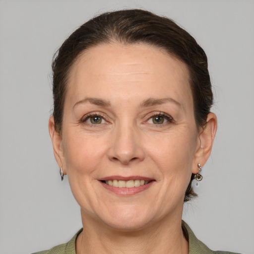 Joyful white adult female with short  brown hair and grey eyes