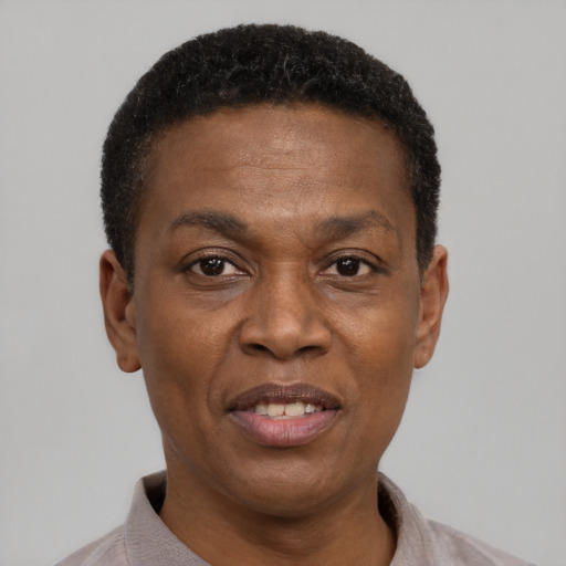 Joyful black adult male with short  black hair and brown eyes