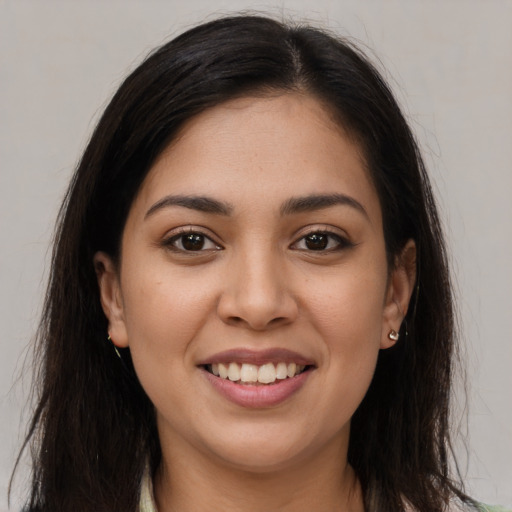 Joyful latino young-adult female with long  brown hair and brown eyes