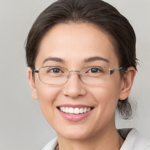 Joyful white young-adult female with medium  brown hair and brown eyes