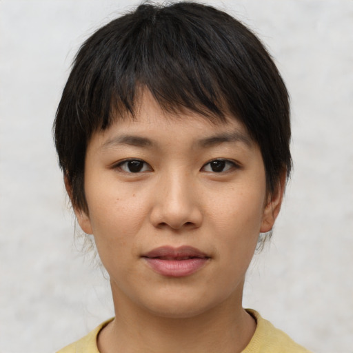 Joyful asian young-adult female with short  brown hair and brown eyes