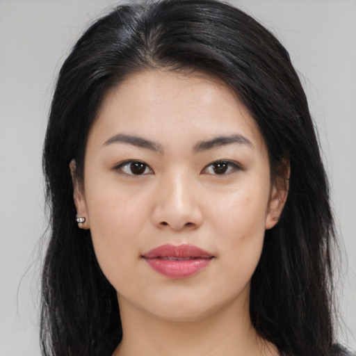 Joyful asian young-adult female with long  brown hair and brown eyes