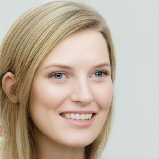 Joyful white young-adult female with long  brown hair and blue eyes