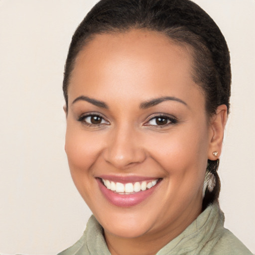 Joyful latino young-adult female with long  brown hair and brown eyes