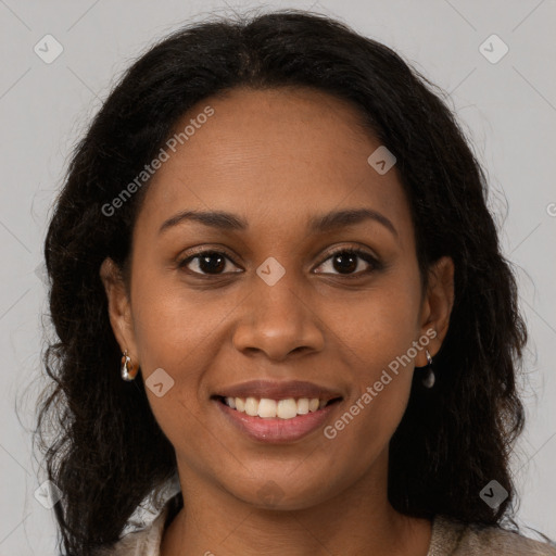 Joyful black young-adult female with long  brown hair and brown eyes