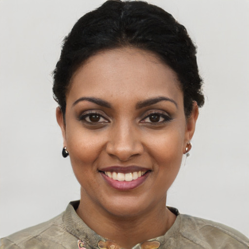 Joyful black young-adult female with short  black hair and brown eyes