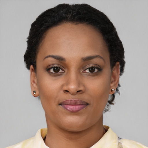 Joyful black young-adult female with short  brown hair and brown eyes