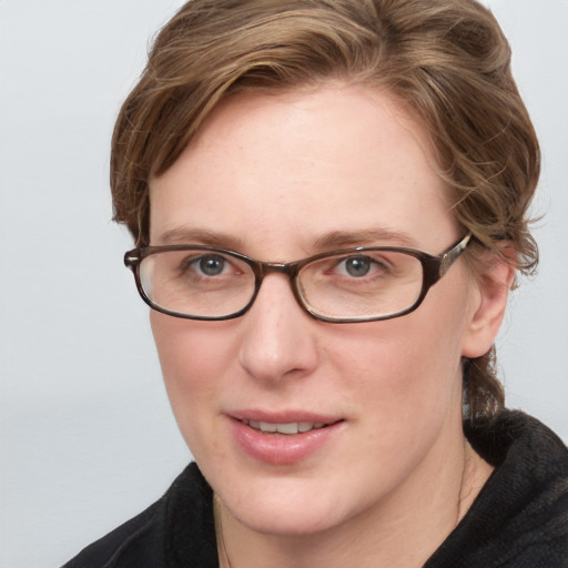 Joyful white adult female with medium  brown hair and blue eyes