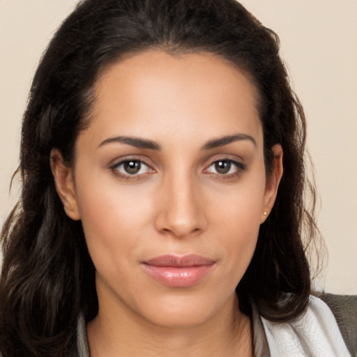 Joyful latino young-adult female with long  brown hair and brown eyes