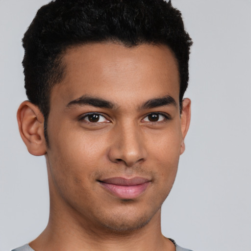 Joyful latino young-adult male with short  brown hair and brown eyes