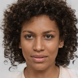 Joyful black young-adult female with medium  brown hair and brown eyes