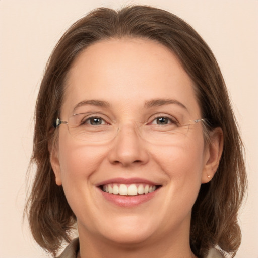 Joyful white adult female with medium  brown hair and grey eyes