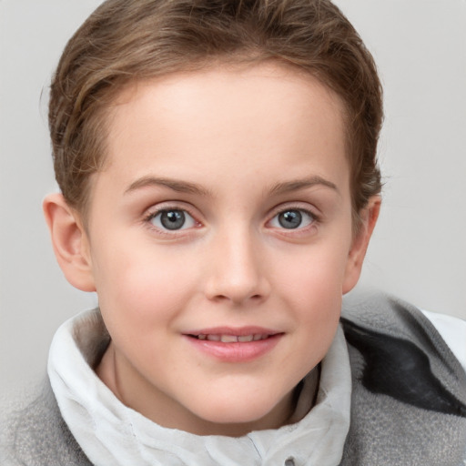 Joyful white child female with short  brown hair and blue eyes