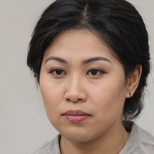 Joyful asian young-adult female with medium  brown hair and brown eyes