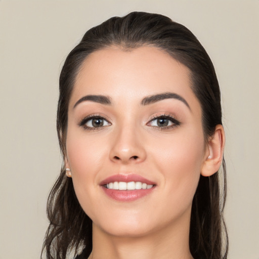 Joyful white young-adult female with long  brown hair and brown eyes