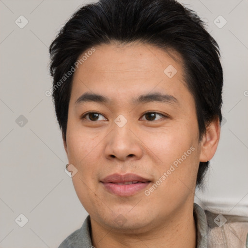 Joyful asian young-adult male with short  brown hair and brown eyes